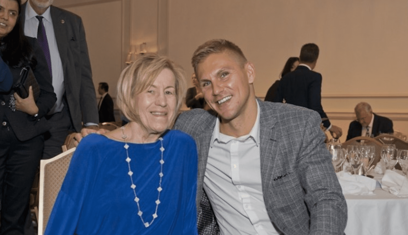 Smiling woman and man at formal event.